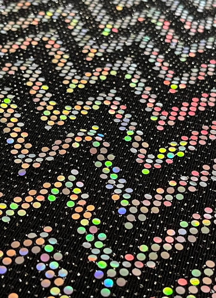 Close-up of black holographic fabric with reflective rainbow chevron pattern used for the OTKYDACH full face mask