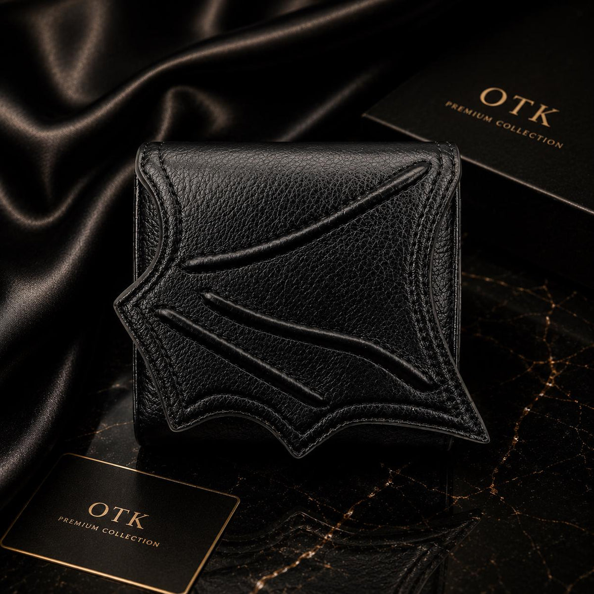 Black textured leather wallet with embossed wing pattern, dark aesthetic