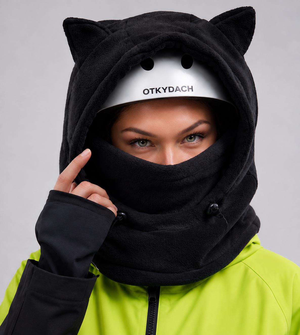 Black fleece ski hood with cat ears worn over a white helmet, OTKYDACH logo on front