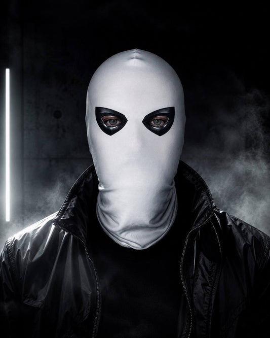 White balaclava with black eye frames worn by model in cinematic studio